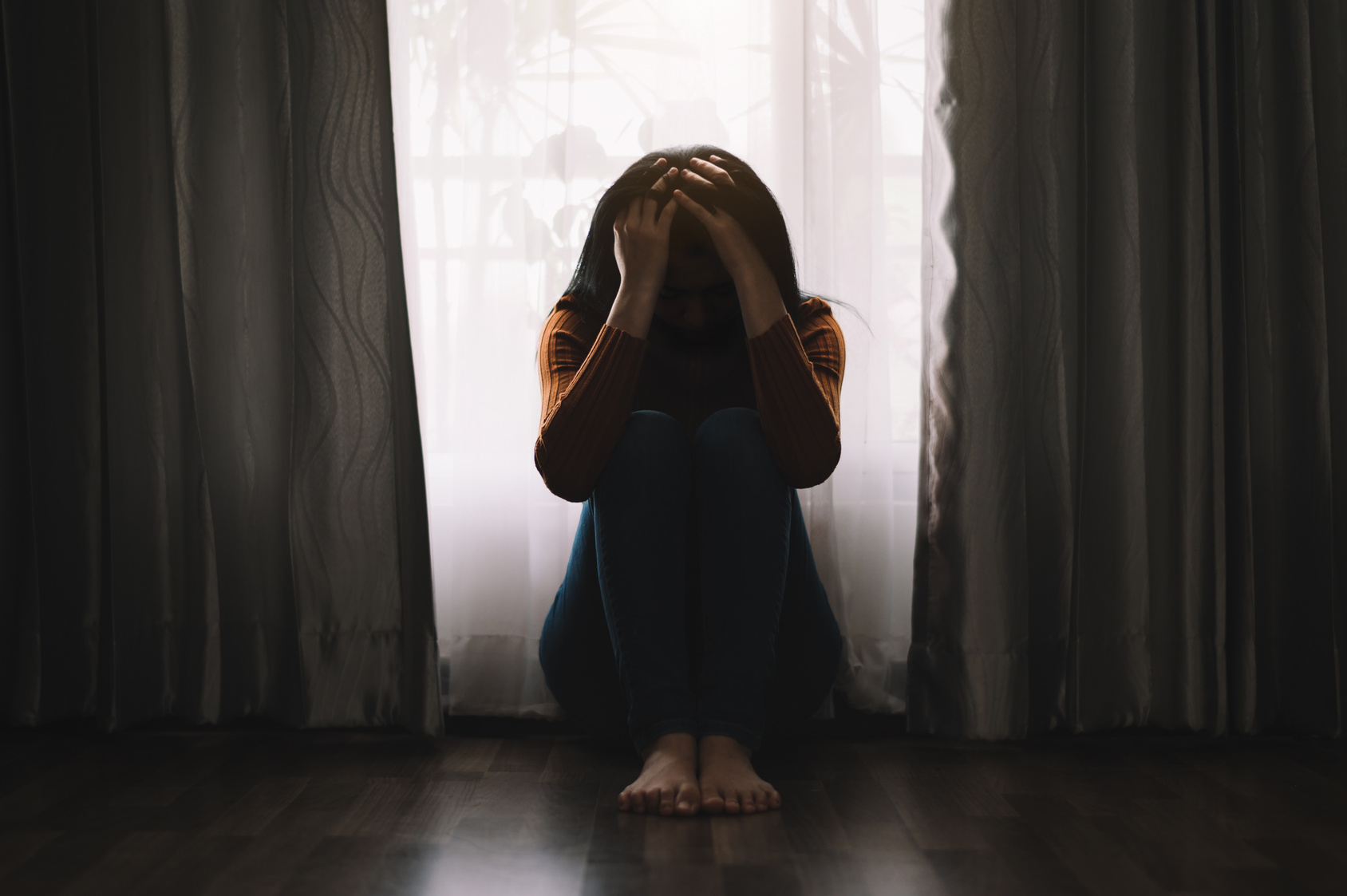 woman sit Depression Standing by window